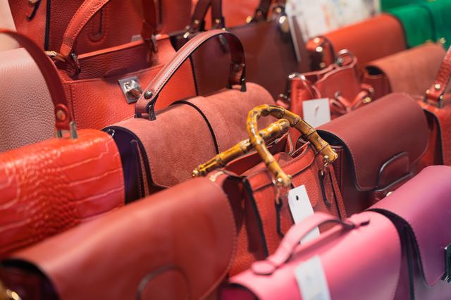 Rack of luxury handbags in a boutique